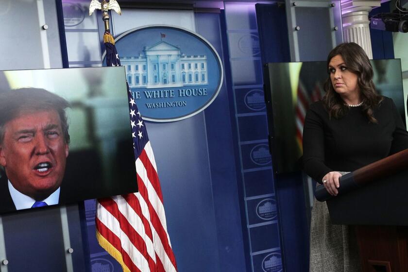 WASHINGTON, DC - JANUARY 04: U.S. President Donald Trump speaks via a video as White House Press Secretary Sarah Sanders listens during a daily news briefing at the James Brady Press Briefing Room of the White House January 4, 2018 in Washington, DC. Sanders spoke on various topics including the new book "Fire and Fury", written by Michael Wolff. (Photo by Alex Wong/Getty Images) ** OUTS - ELSENT, FPG, CM - OUTS * NM, PH, VA if sourced by CT, LA or MoD **