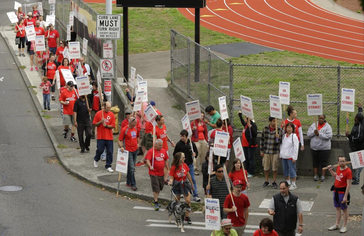 Striking Seattle Public Schools teachers and others walk a picket line last week.