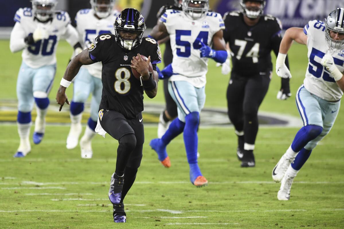 Baltimore Ravens quarterback Lamar Jackson runs the ball for a first half touchdown against the Dallas Cowboys.