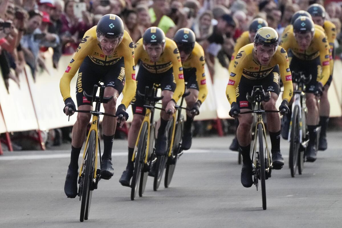 Jumbo Visma team riders with new overall leader Robert Gesink of The Netherlands, left, cross the finish line during the first stage of the Vuelta cycling race, a team time trial over 23.3 kilometers (14.5 miles) with start and finish in, Utrecht, Netherlands, Friday, Aug. 19, 2022. (AP Photo/Peter Dejong)