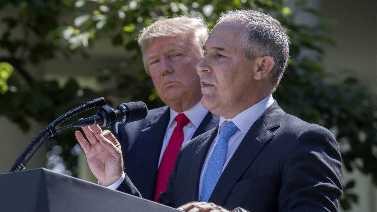 Donald Trump listens as EPA Administrator Scott Pruitt delivers remarks at the White House on June 1, 2017.