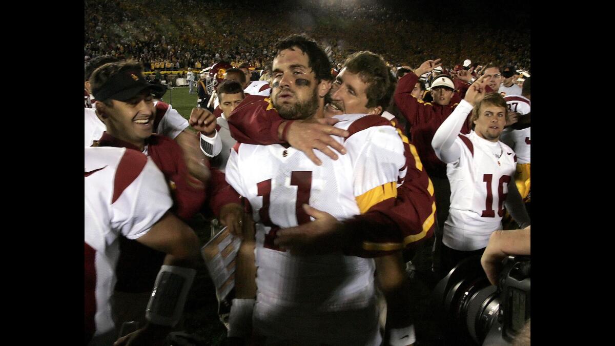 USC quarterback Matt Leinart lets out a sigh of relief as offensive line coach Pat Reul gives him a hug after the 34-31 victory over Notre Dame on Oct. 15, 2005.