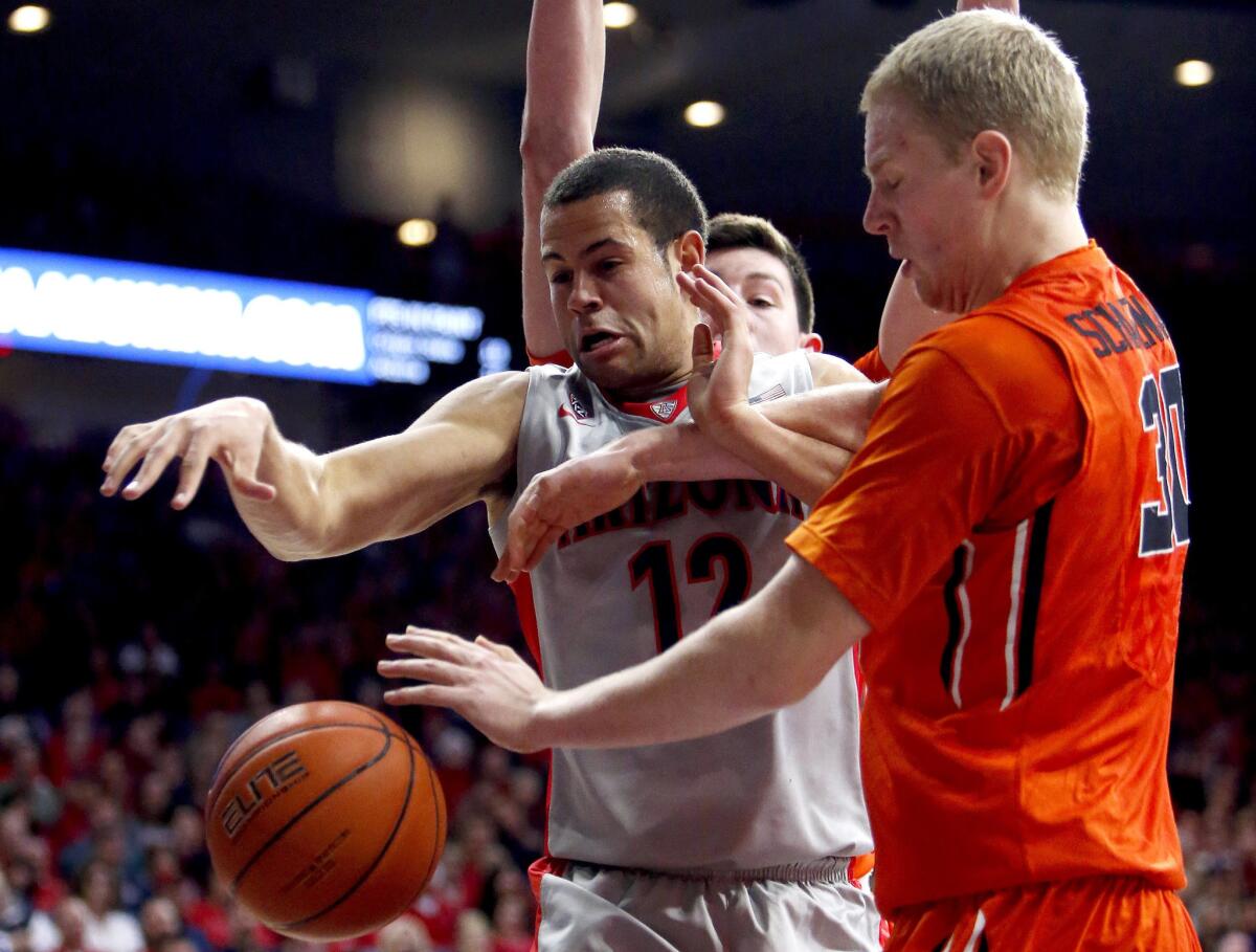 Arizona forward Ryan Anderson and Oregon State forward Olaf Schaftenaar vie for a loose ball during the second half of a game on Jan. 30.
