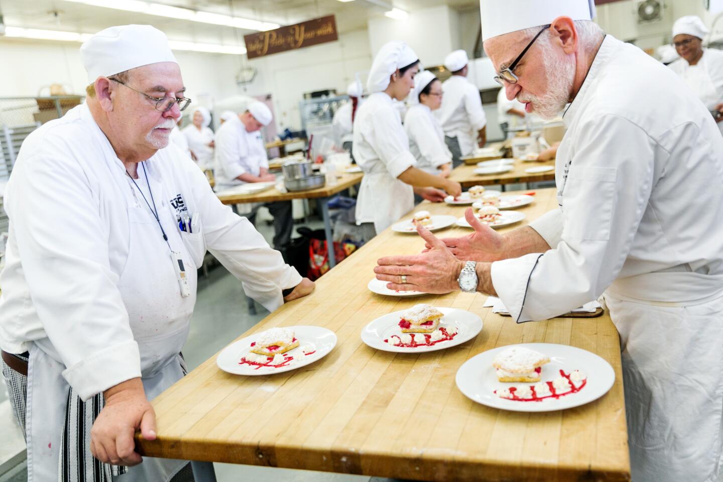 Melvin Norell, left, gets feedback from instructor Robert Wemischner in culinary class at Los Angeles Trade Tech.