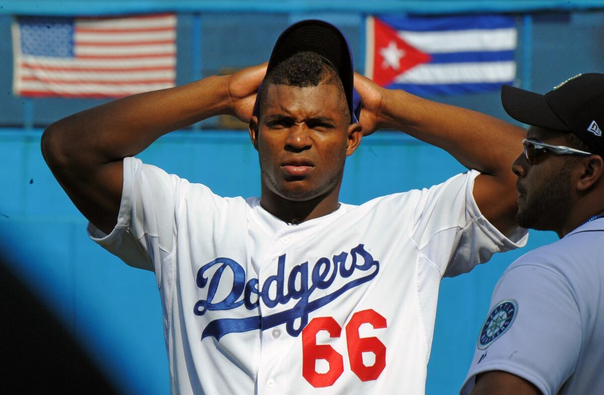 Yasiel Puig takes part in a children's baseball clinic in Havana on Dec. 16.