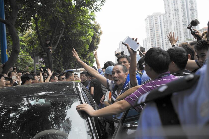 Drivers of Didi Kuaidi, Uber’s biggest rival in China, protest an attempt to arrest a fellow driver in Guangzhou on June 10. Uber has faced government raids, police crackdowns and cab driver protests.