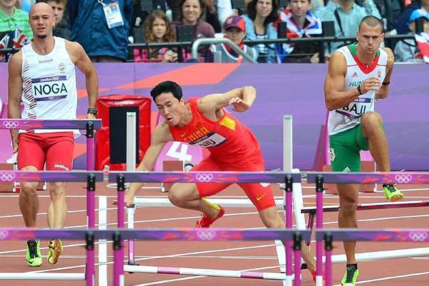 China's Liu Xiang falls while competing in the men's 110-meter hurdles heats.