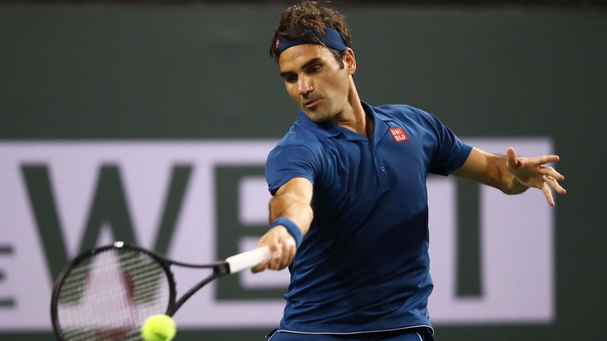 Roger Federer plays a forehand against Stan Wawrinka during their men's singles third round match at the BNP Paribas Open at the Indian Wells Tennis Garden on Tuesday in Indian Wells.