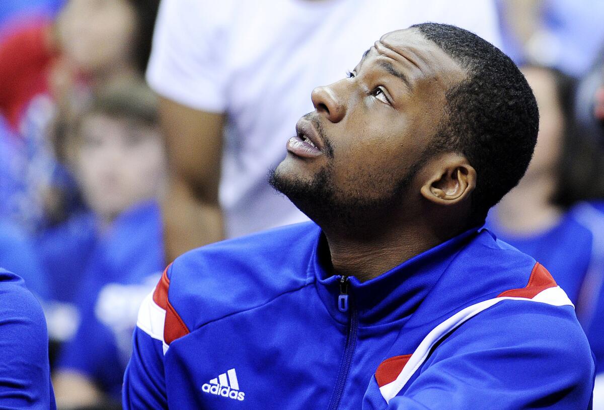 Kansas' Cliff Alexander sits on the bench during a Jayhawks game on March 13.