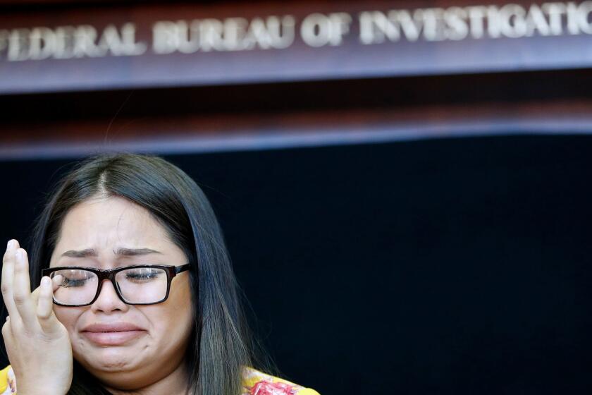 Dysabel Munguia cries as she speaks during a news conference to announce the addition of fugitive Jesus Munguia to the FBI's Top 10 most wanted list Monday, Nov. 13, 2017, in Las Vegas. Jesus Munguia is wanted for the alleged murder of Sherryl Sacueza in Las Vegas in 2008. Dysabel Munguia is the daughter of Sacueza. (AP Photo/John Locher)