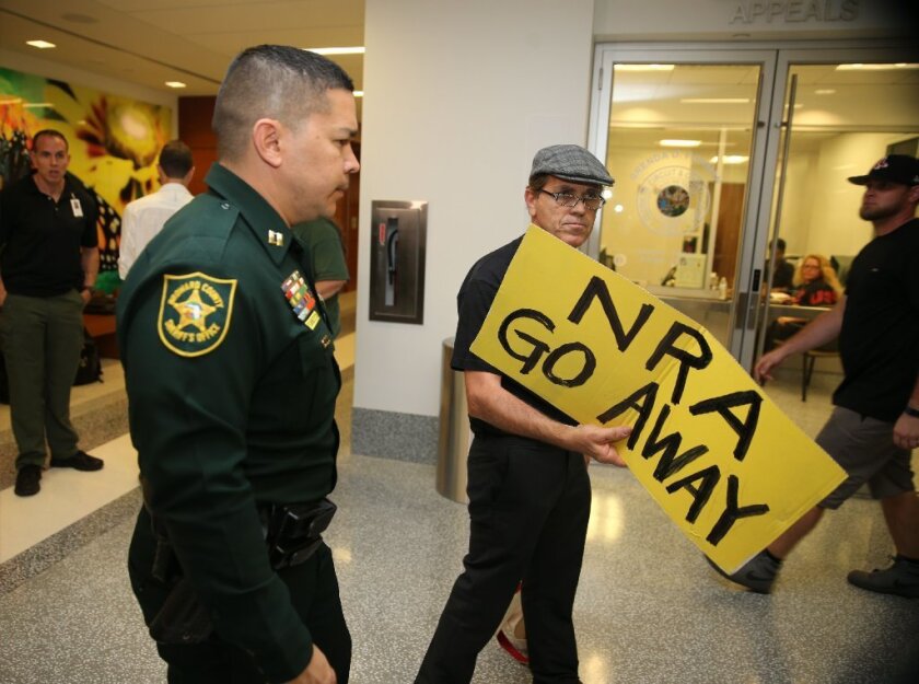 People protest against the National Rifle Association at the Broward County Court House during the first appearance in court via video link for high school shooter Nikolas Cruz February 15, 2018 in Fort Lauderdale, Florida.