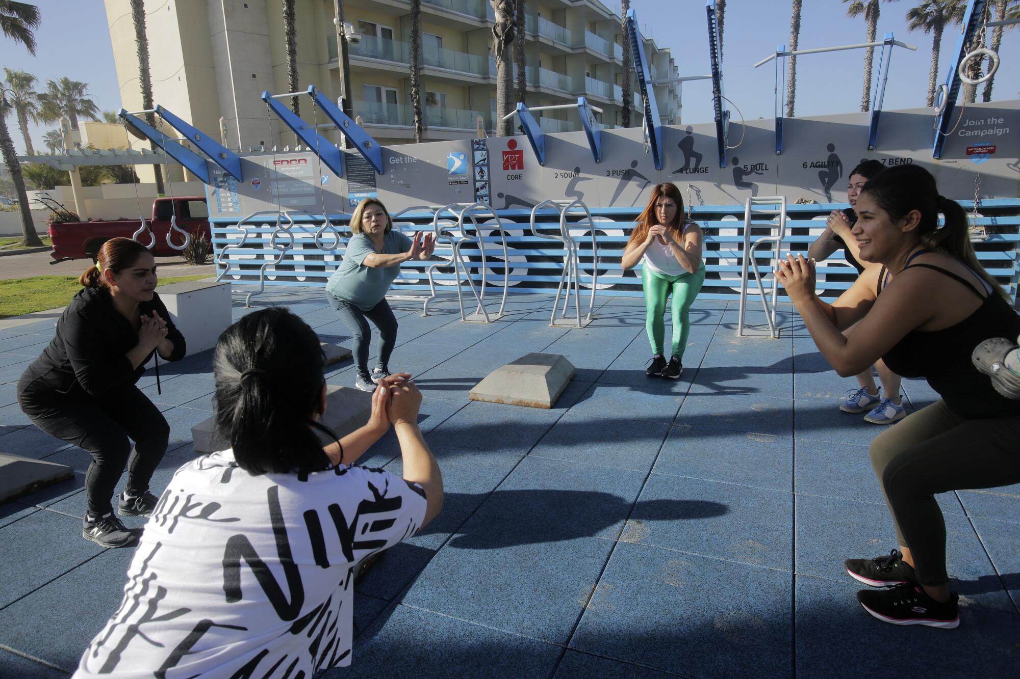 A group of women from the Herbal Life community workout group exercise at Dunes Park on Thursday, March 17, 2022