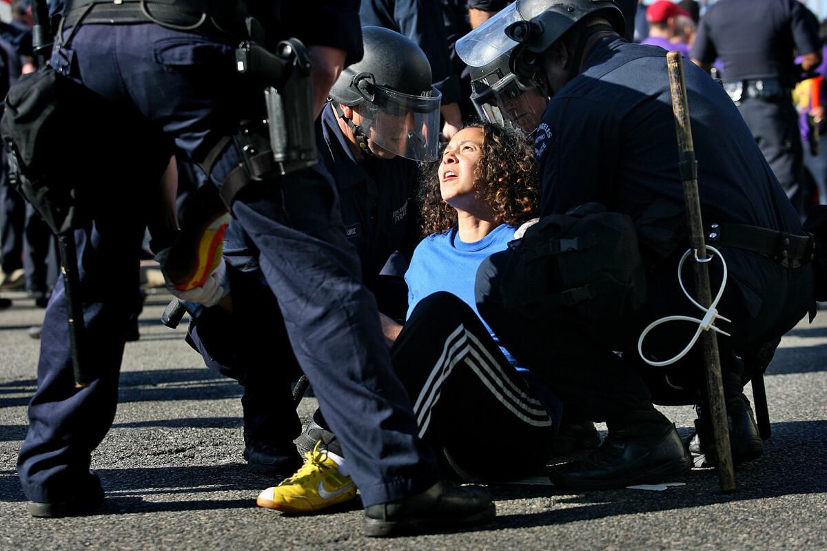 A union activist is arrested by LAPD during a demonstration at LAX in 2012 just before Thanksgiving. Hundreds of airport workers turned out to protest the actions of Aviation Safeguards, whose workers voted to terminate a union contract.