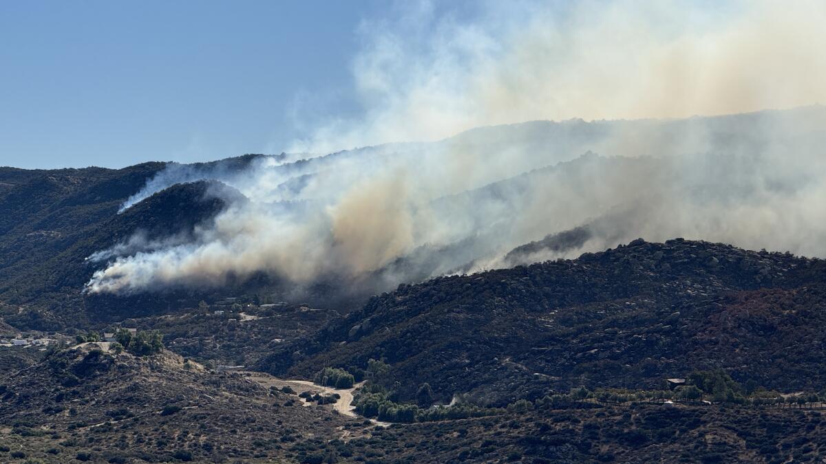 The wind-whipped Highland fire burns through vegetation and structures in Riverside County on Oct. 31. 