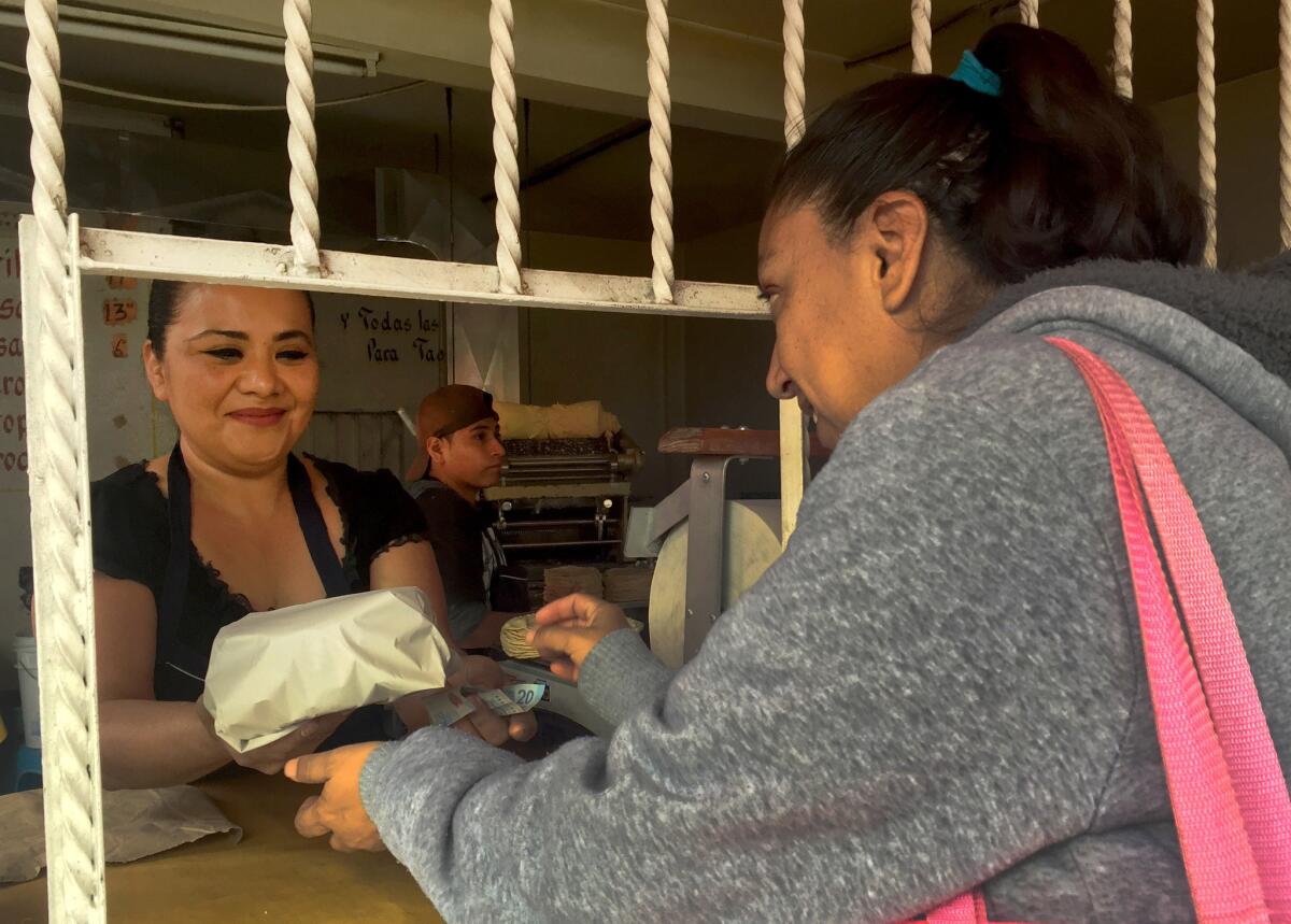Sophia Cruz, left, who owns a corner store called Tortilleria Mexico in Nezahualcoyotl, Mexico, has refused to lower prices for her tortillas. She's lost business to others that receive assistance from a local political candidate in exchange for free advertising.