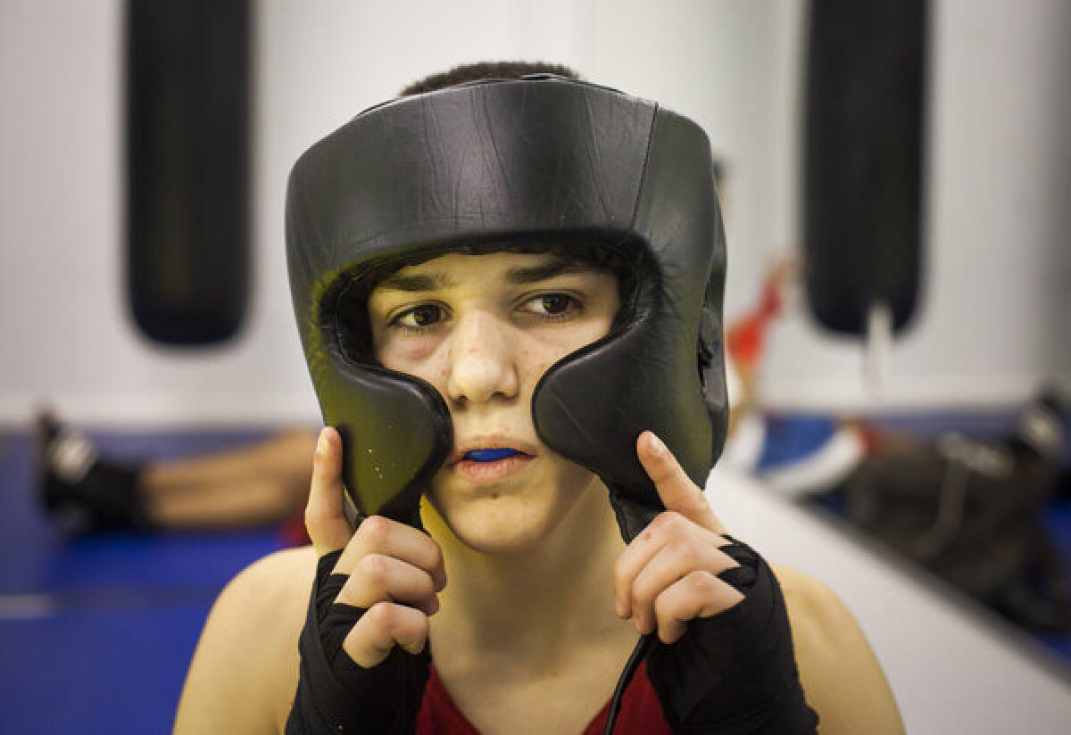 Reshat Mati, a 14-year-old who is ranked No. 1 in the world in his age division by the International Kickboxing Federation, puts on his headgear before a kickboxing workout at Bars gym in Staten Island.