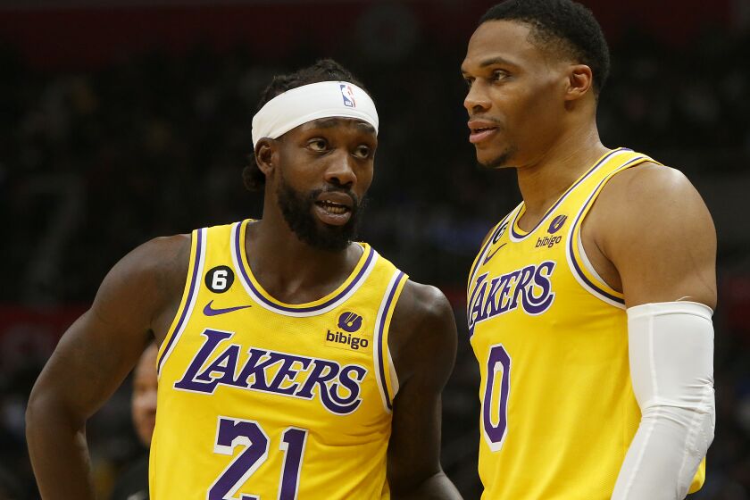 LOS ANGELES, CALIF. - NOV. 9, 2022. Laker guards Patrick Beverley, left, and Russell Westbrook talk during a break in the action of the game against the Clippers at Crypto.com Arena in Los Angeles on Wednesday night, Nov. 9, 2022. (Luis Sinco / Los Angeles Times)