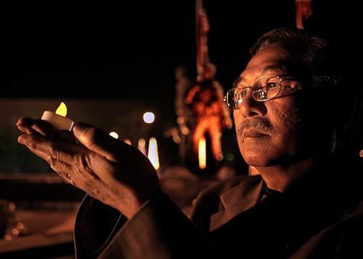 Timothy Thieng Chi Ngo, vice president of the Vietnamese American Community of Southern California, holds an electric candle along with several hundred others in Westminster to commemorate the thirty-third anniversary of the fall of Saigon.