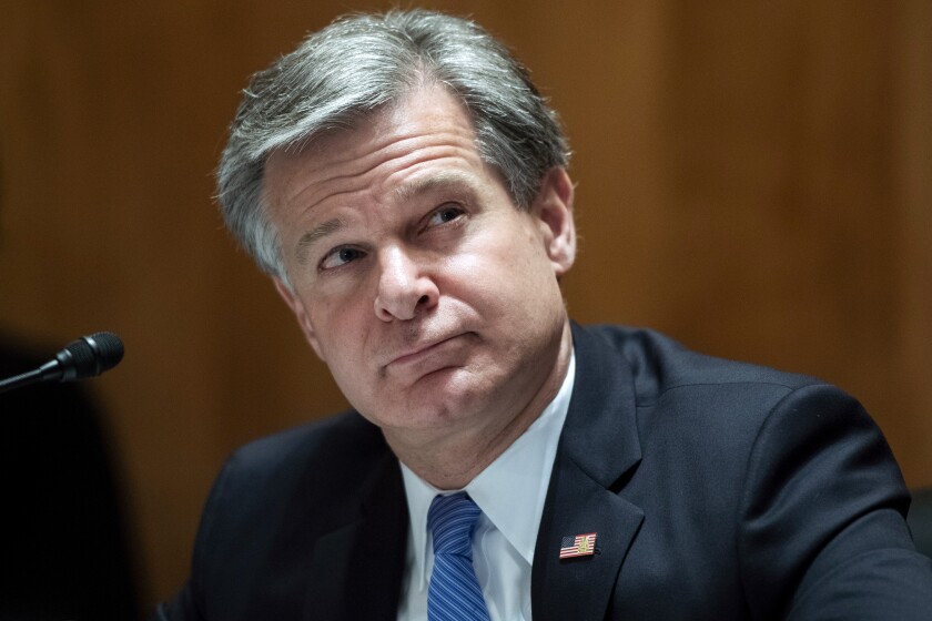 FILE - In this Sept. 24, 2020 file photo, FBI Director Christopher Wray, testifies during a Senate Homeland Security and Governmental Affairs Committee hearing on "Threats to the Homeland" on Capitol Hill in Washington. Wray is seeking to reassure agents that the bureau won't tolerate sexual misconduct in the workplace, promising more resources for victims and full investigations into claims brought against FBI officials — “regardless of rank or title.” Wray sent a lengthy statement to staff late last week following an Associated Press investigation that found multiple senior FBI officials were accused of sexual misconduct over the past five years. (Tom Williams/Pool via AP, File)
