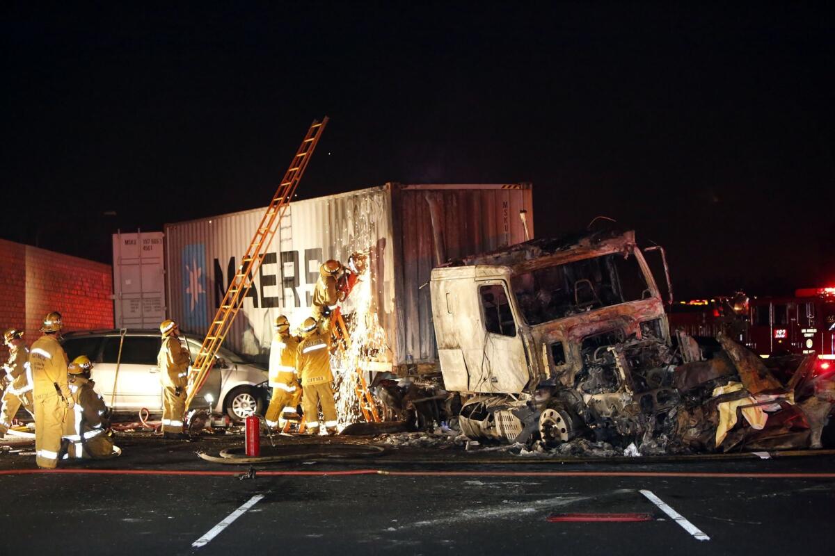 Fire crews work at the fatal accident on the 10 Freeway near Pomona.