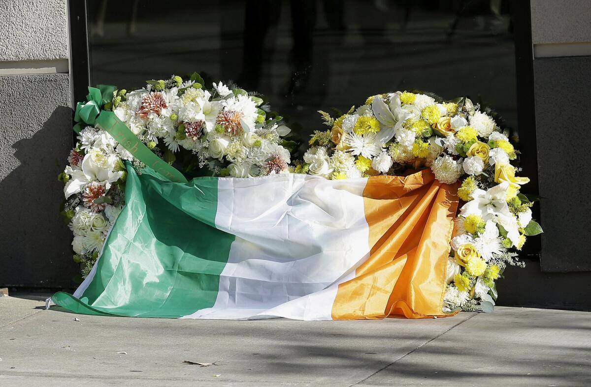 A flag of Ireland is draped over wreaths at the Library Gardens apartment complex in Berkeley on June 16.
