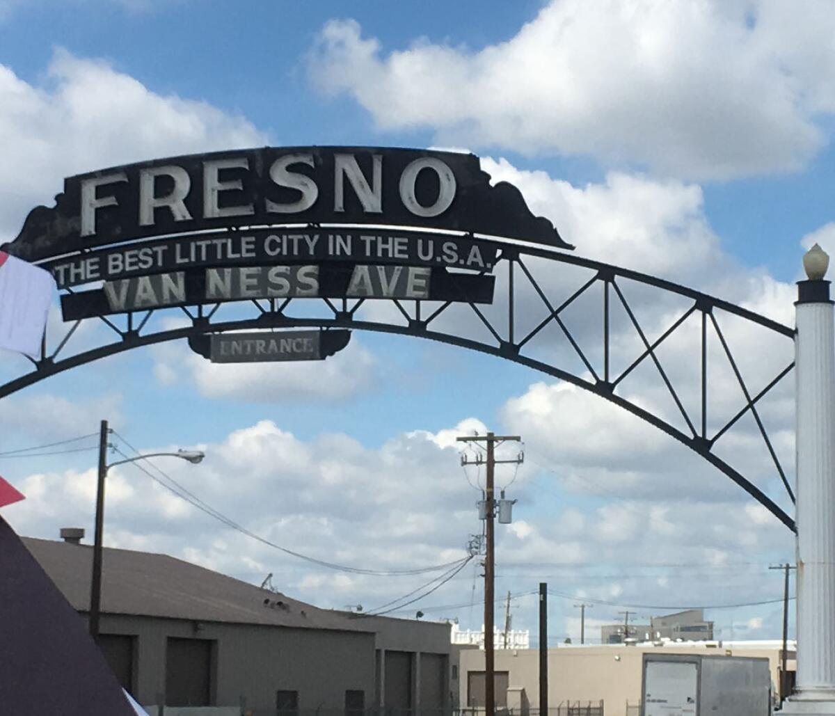 A large sign reads "Fresno: The best little city in the USA."