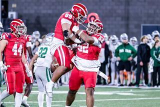 Mater Dei's Tomuhini Topui (52) celebrates with Semi Taulanga after beating De La Salle to complete 13-0 season.