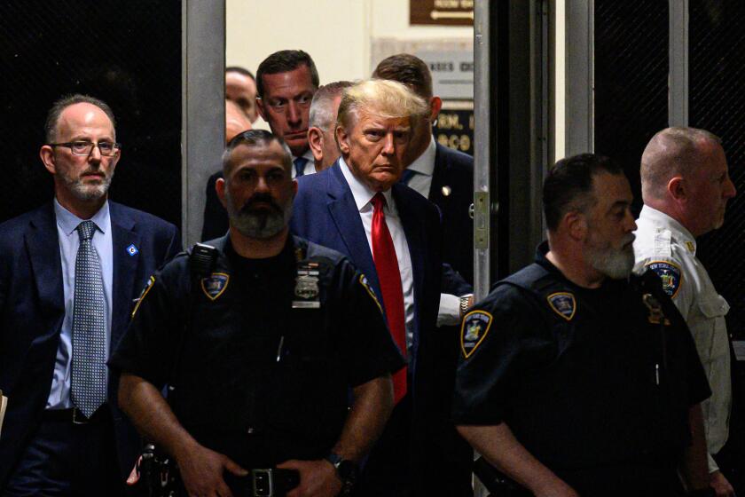 Former US President Donald Trump makes his way inside the Manhattan Criminal Courthouse in New York on April 4, 2023. - Donald Trump will make an unprecedented appearance before a New York judge on April 4, 2023 to answer criminal charges that threaten to throw the 2024 White House race into turmoil. (Photo by Ed JONES / AFP) (Photo by ED JONES/AFP via Getty Images)