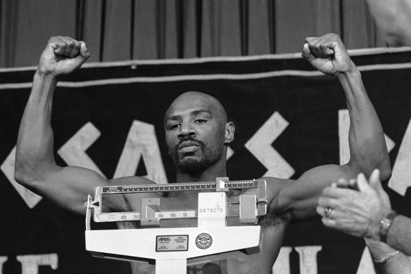 April 15, 1985 -- Middleweight champion Marvin Hagler steps on the scales and raises his arms at the weigh-in for his title fight with Tommy Hearns in Las Vegas.