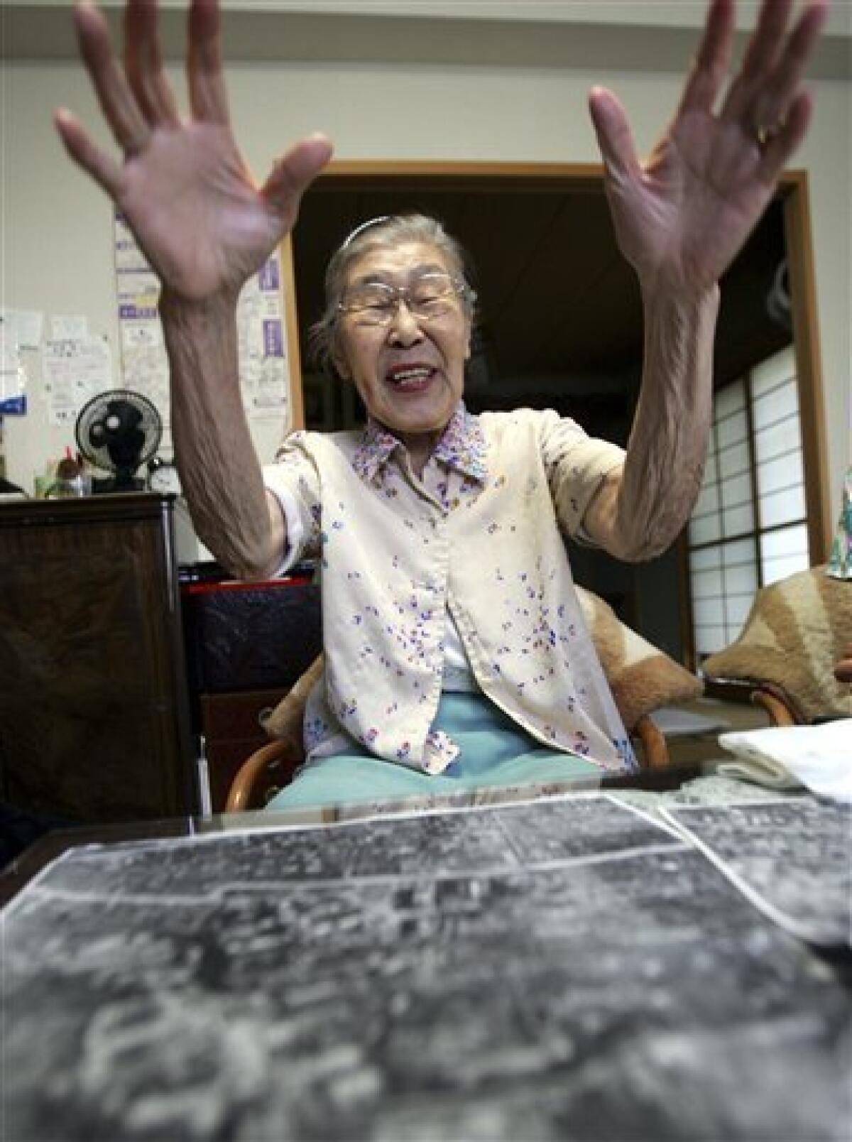 In this July 29, 2006 file photo, with aerial photos of the city of Tokyo, Toyo Ishii, a former military nurse, speaks about Unit 731, Japan's germ and biological warfare outfit during World War II, at her home in Tokyo. Japan is launching a land survey that may dig up evidence of its grisly WWII secrets. The excavation begins Monday, Feb. 21, 2011, at the former site of a wartime medical school related to Tokyo's shadowy wartime experiments on live prisoners of war, an atrocity Japan's government has never officially recognized but well documented by historians and participants. The first government probe of the site linked to Unit 731 follows Ishii's revelation five years ago. (AP Photo/Itsuo Inouye, File)