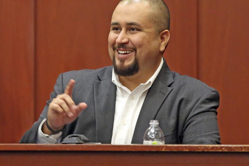 FILE- In this Sept. 13, 2016 file photo, George Zimmerman smiles as he testifies in a Seminole County courtroom in Orlando, Fla. Zimmerman, who was acquitted of the 2012 killing of an unarmed black teen Trayvon Martin, has filed a lawsuit, Wednesday, Dec. 4, 2019, against the teens' parents, family attorney and prosecutors who tried his case, claiming they coached a witness to give false testimony. (Red Huber/Orlando Sentinel via AP, Pool, File)