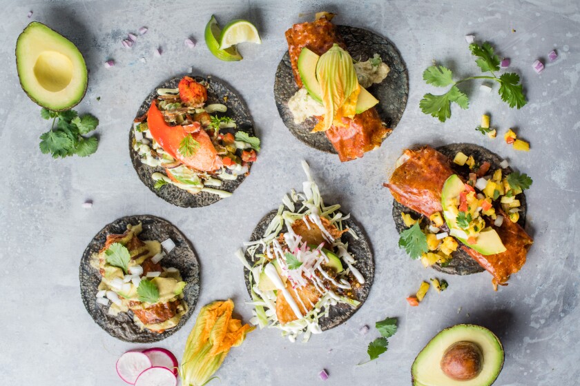 Five varieties of tacos at Puesto, specializing in Mexican-style tacos.