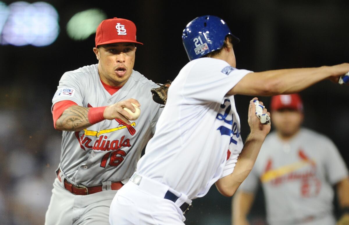 Dodgers pitcher Zack Greinke tries to avoid a tag by Cardinals second baseman Kolten Wong in the third inning. Wong tagged him with his glove while holding the ball in the other hand. Greinke was eventually awarded second base on the play. He would later score.
