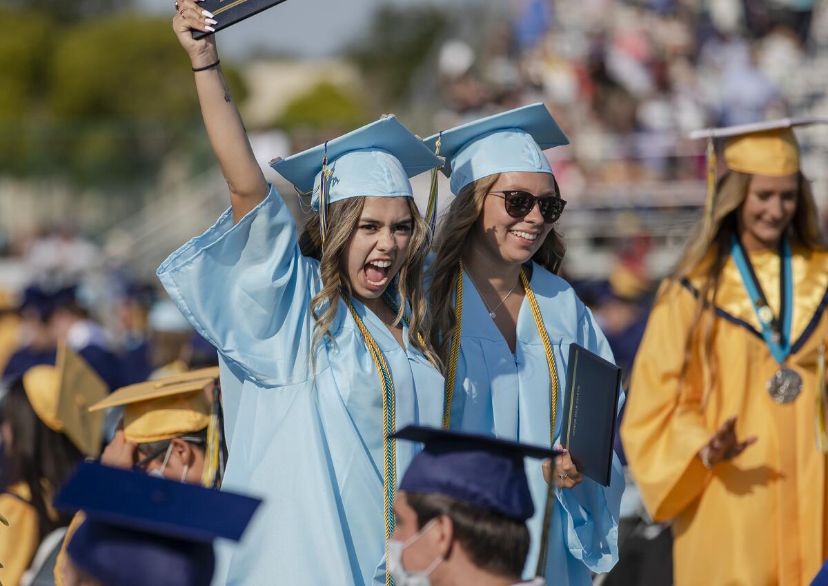 Andrea Vergara, left, and Lexi VanHorn celebrate during the Marina High School graduation on Thursday, June 17.