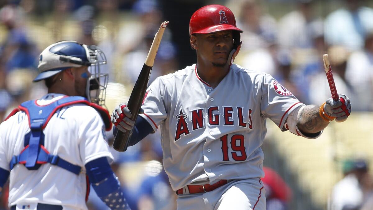 Angels' Jefry Marte breaks his bat over his leg after striking out on a full-count pitch from Dodgers starting pitcher Clayton Kershaw to end the top of the first inning, leaving the bases loaded on Sunday at Dodger Stadium.