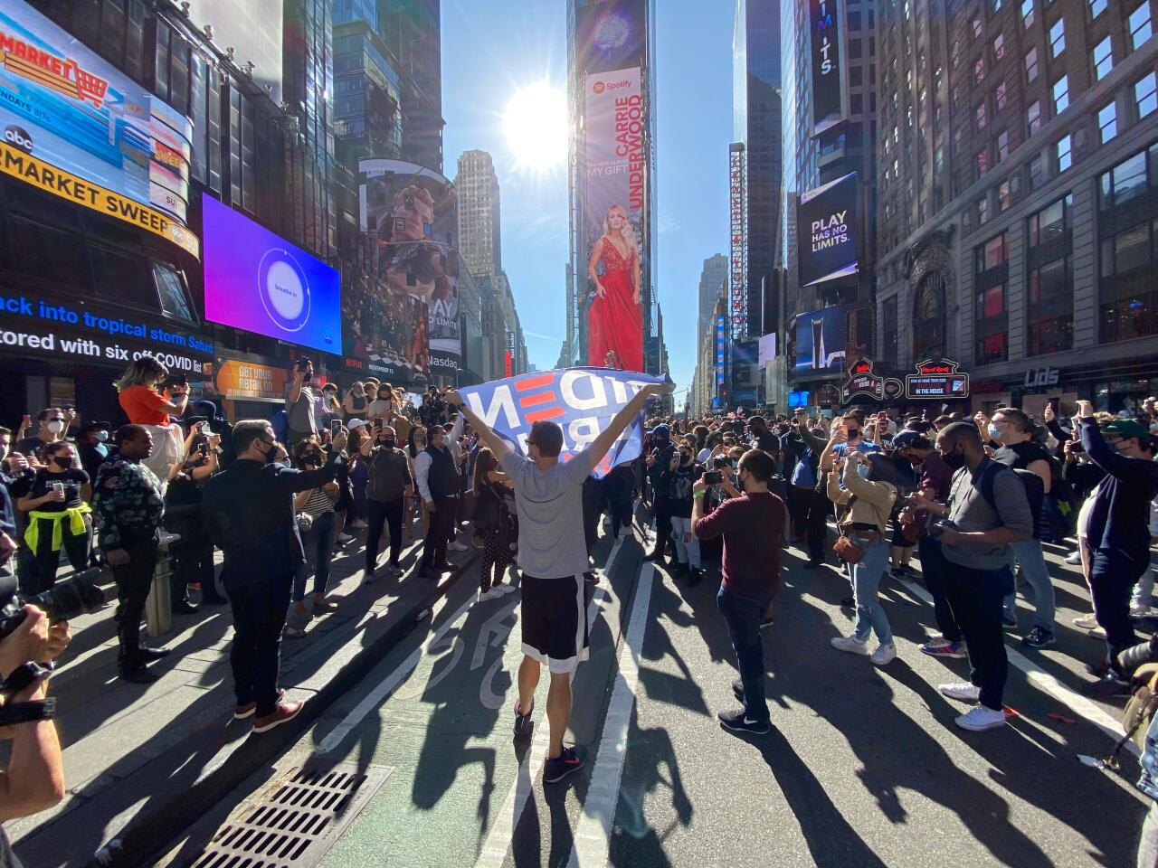 People celebrate at Times Square in New York after Joe Biden was declared winner of the 2020 presidential election.