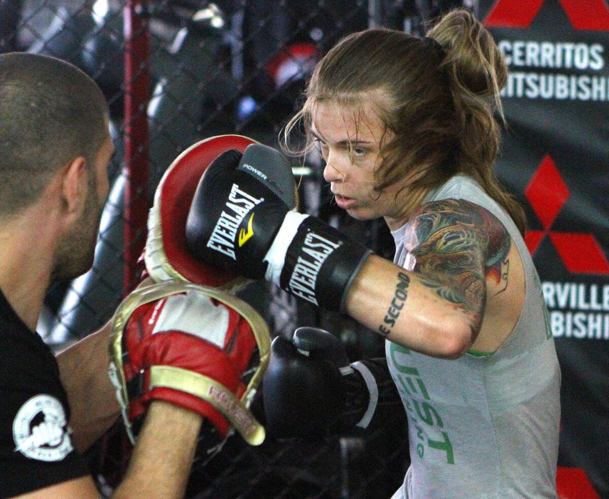 Jessamyn Duke trains with Sevak Ohanjanian at the Glendale Fighting Club on Monday, June 23, 2014.