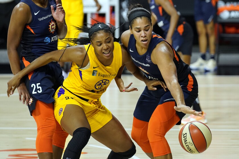 Connecticut Sun center Brionna Jones, right, steals the ball from Sparks center Kristine Anigwe.