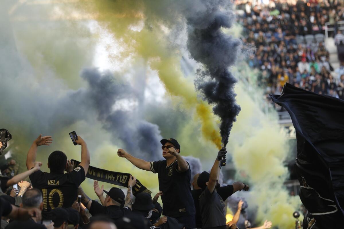 Fans celebrate the LAFC win over the Seattle Sounders in its first game at the brand new Banc of California stadium in Los Angeles on April 29, 2018.