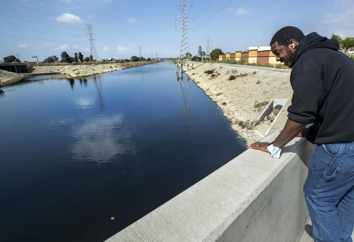 Richard Mootry, who said he works across the street at the Verizon store, looks out at the Dominguez Channel