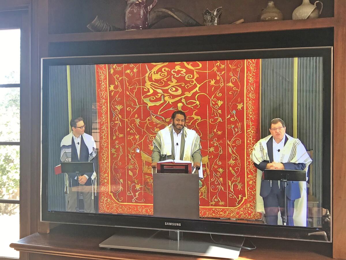 Rabbi Avi Libman, prayer-leader David Lipsitz and Rabbi Ron Shulman live-stream a morning Shabbat service from Stone Family Sanctuary at Congregation Beth El to its website: cbe.org — as seen in March 2020 amid the coronavirus climate.