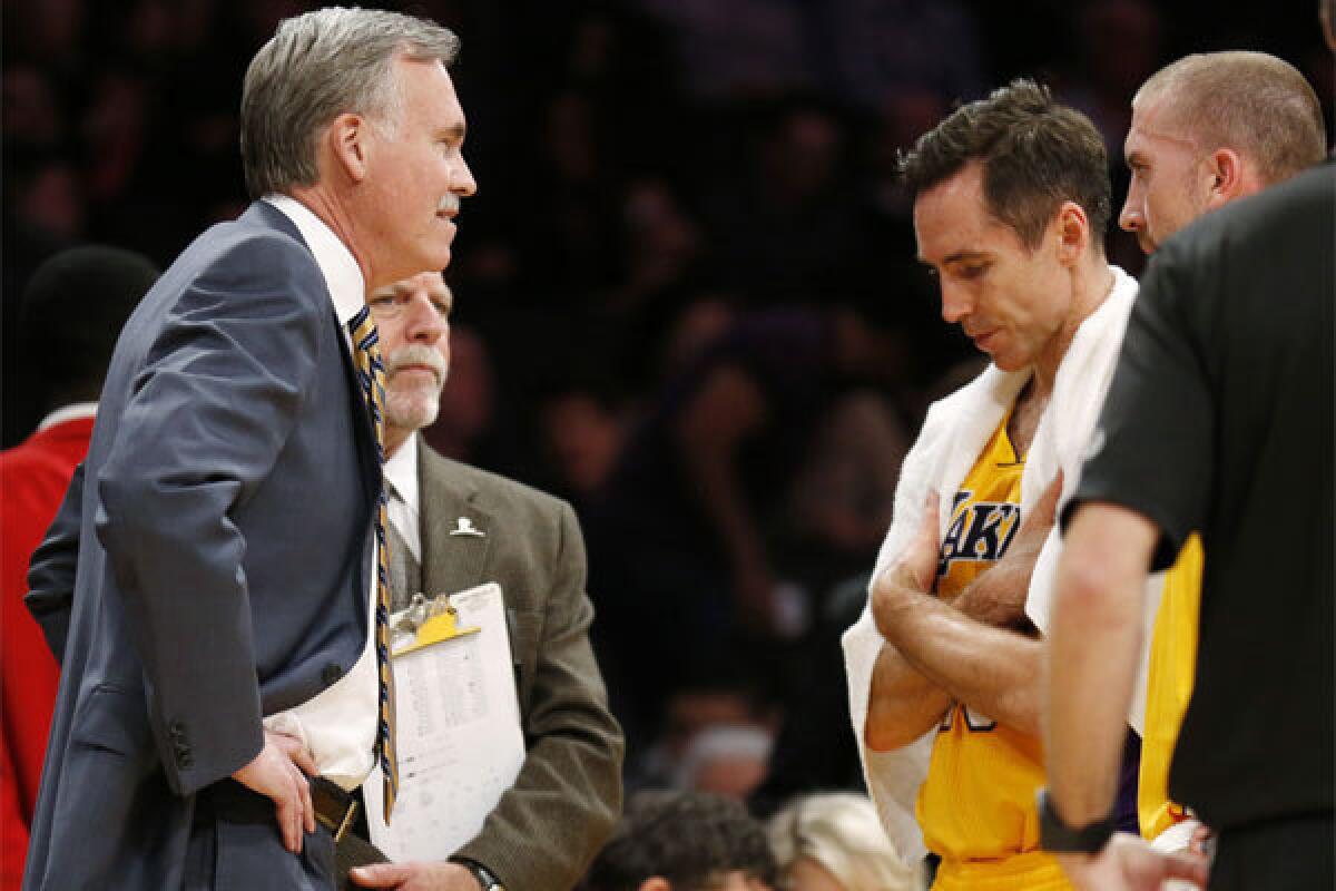Steve Nash talks with Coach Mike D'Antoni during the Lakers' game against Utah on Feb. 11.