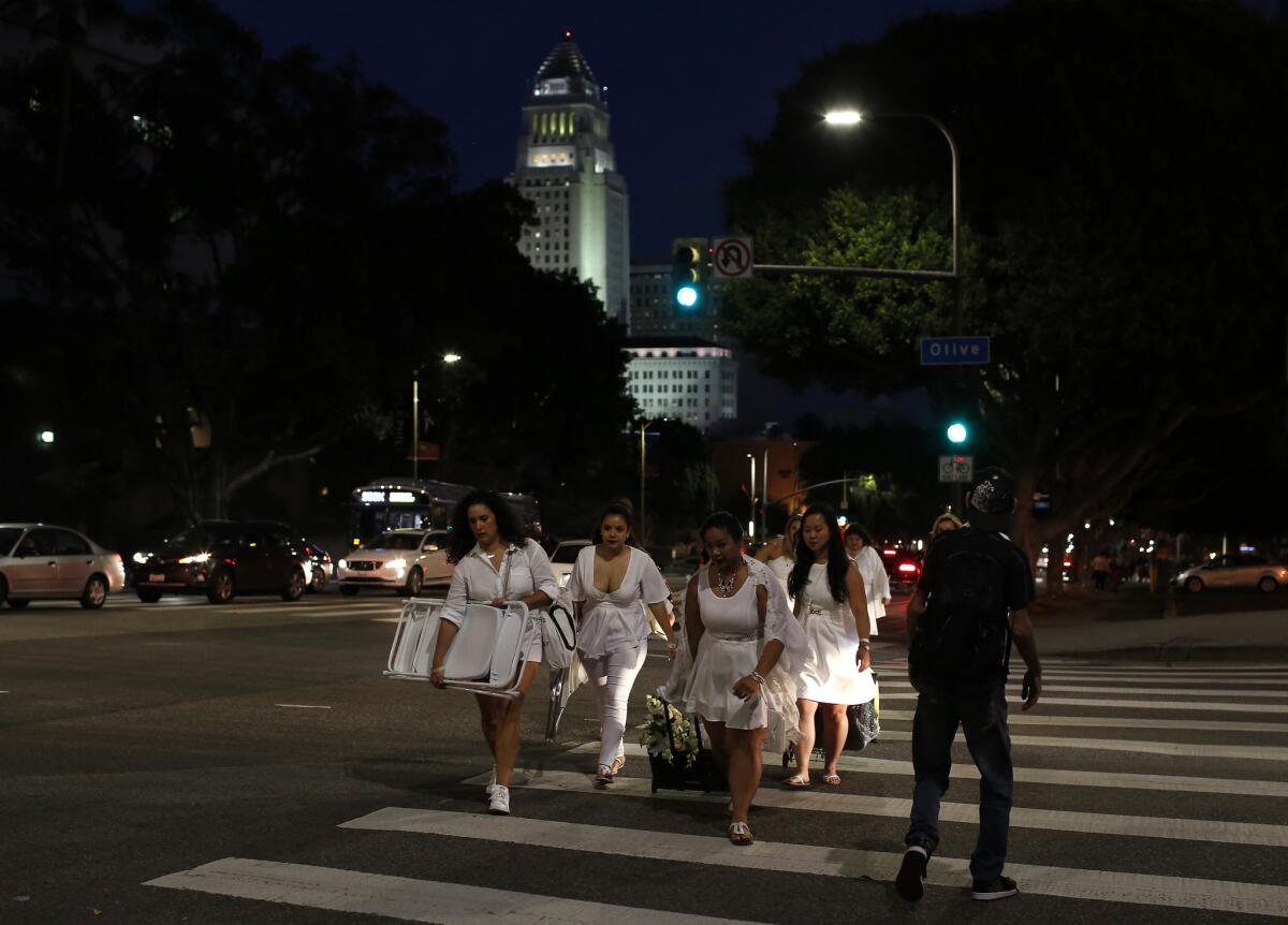 A group makes its way up 1st Street to the Diner en Blanc pop-up dinner in downtown Los Angeles.