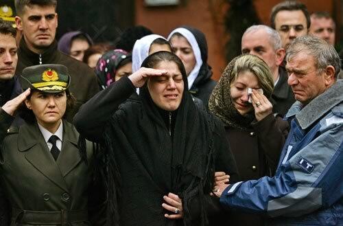 Tugba Eroglu, widow of slain army Capt. Sinan Eroglu, salutes her husband's coffin at his funeral in Istanbul, Turkey, on Wednesday. Eroglu was killed a day earlier during a clash with Kurdish rebels in southeastern Turkey. The army, which reported killing 14 rebels in two days of fighting, said they were among a group that killed 13 soldiers in an Oct. 7 ambush in Sirnak province.