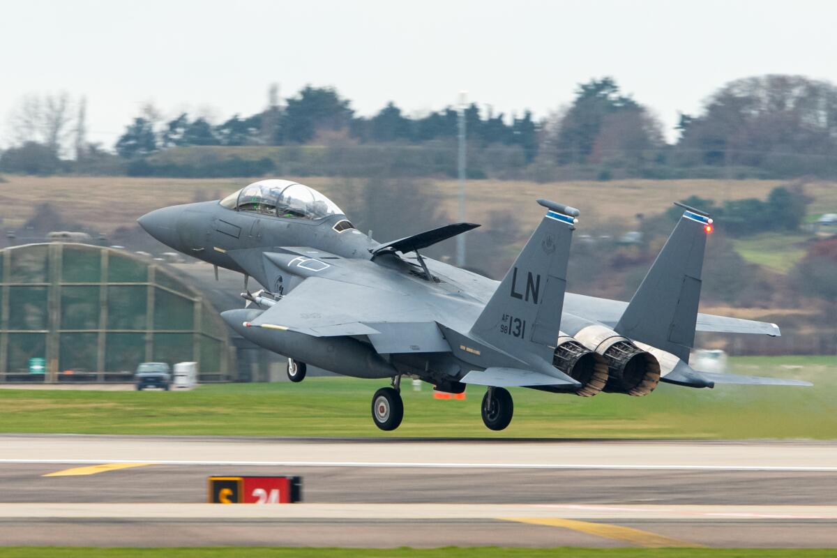 A fighter jet above a runway