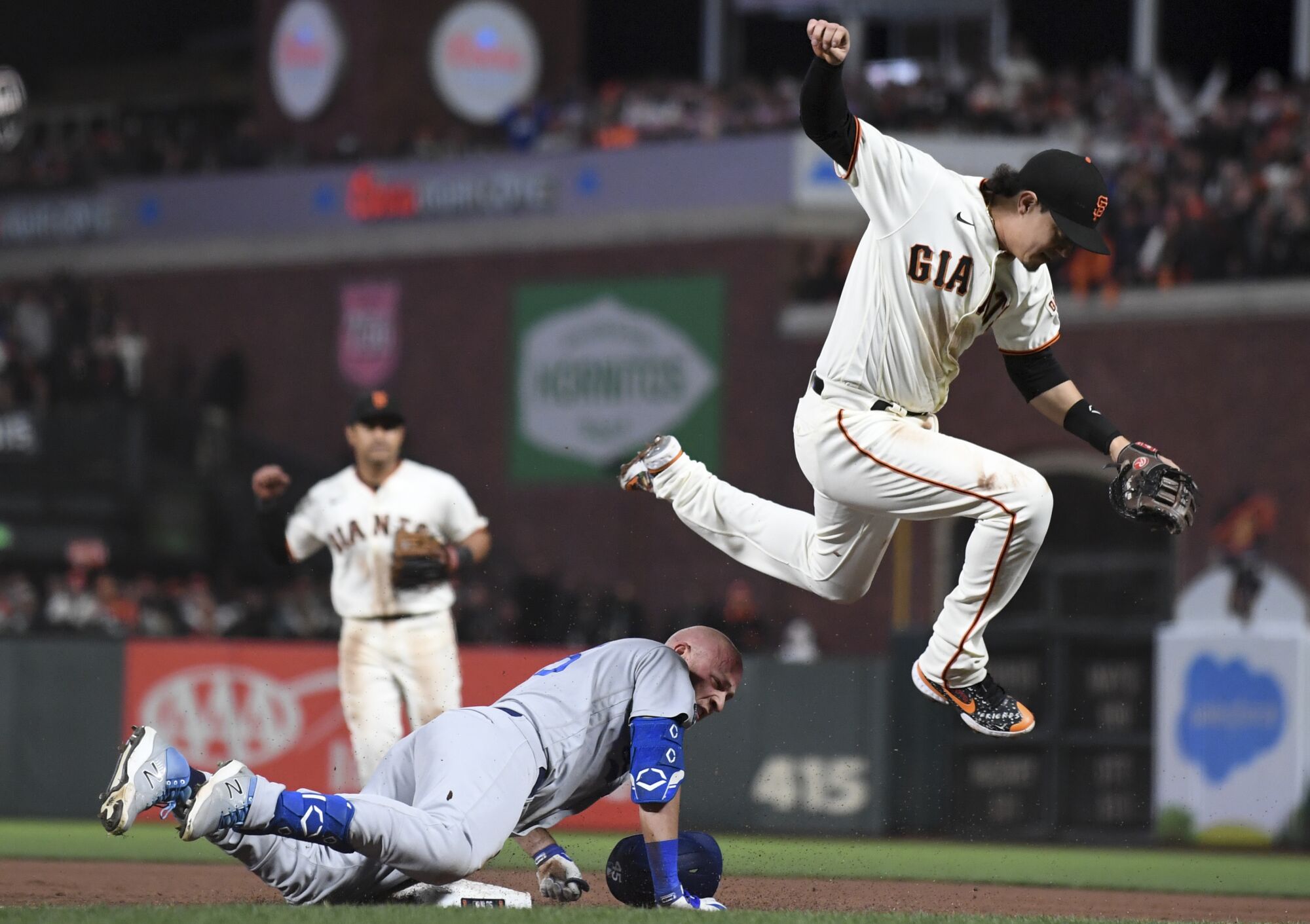 Giants first baseman Wilmer Flores, right, jumps after forcing out Dodgers' Matt Beaty on a ground out