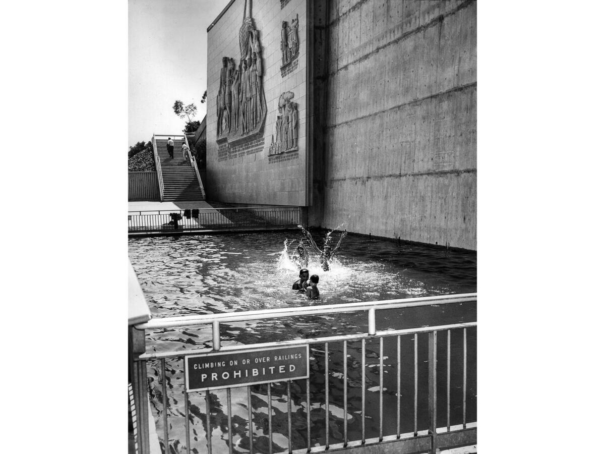 July 9, 1957: Four boys ignore a sign prohibiting entering pool at the Ft. Moore Memorial, and merrily transform it into a downtown swimming pool.