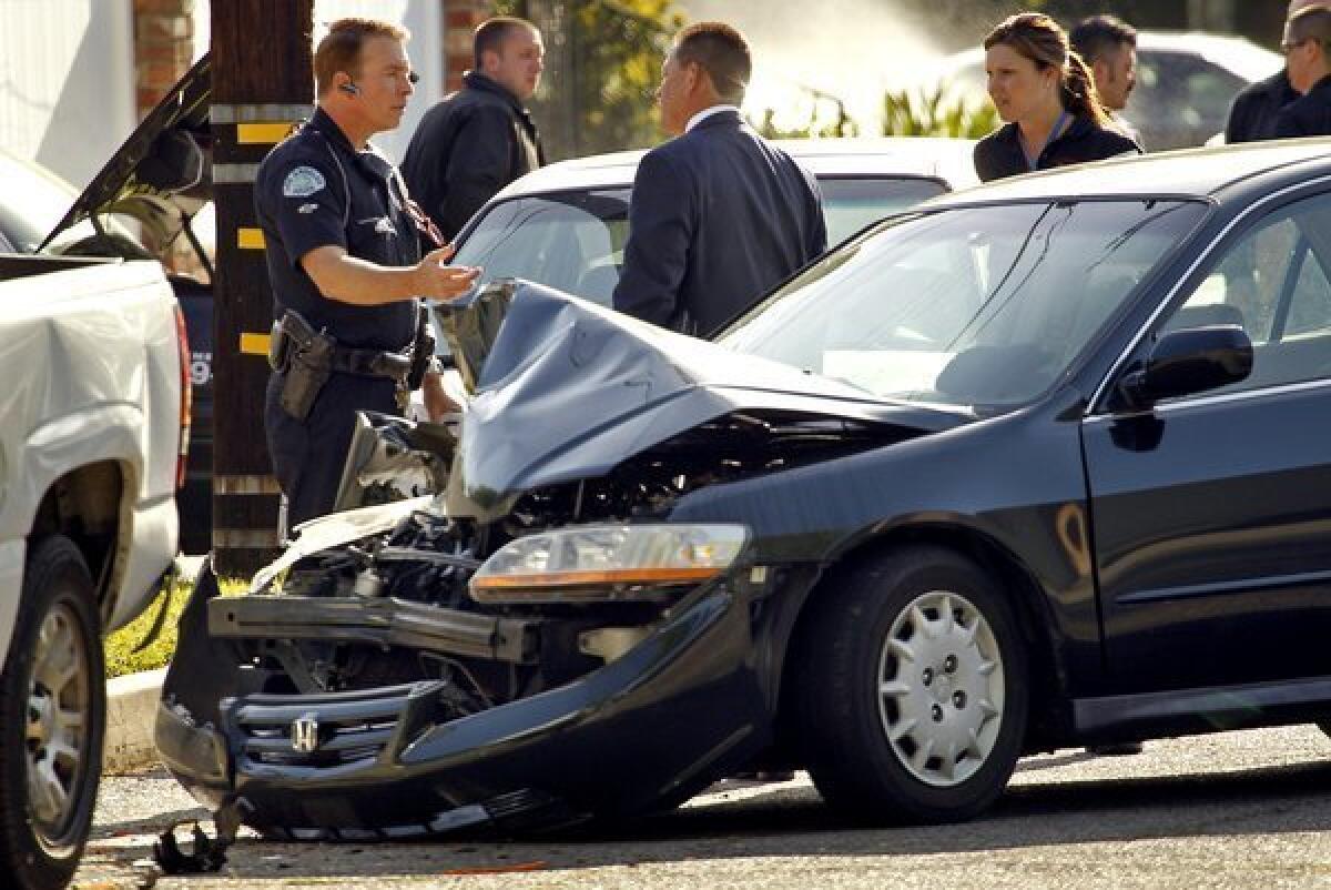 LAPD investigators at the scene of 2011 crash in Los Angeles. A new study found that the 10 ZIP Codes in California with the highest car insurance premiums were in the L.A. metro area.