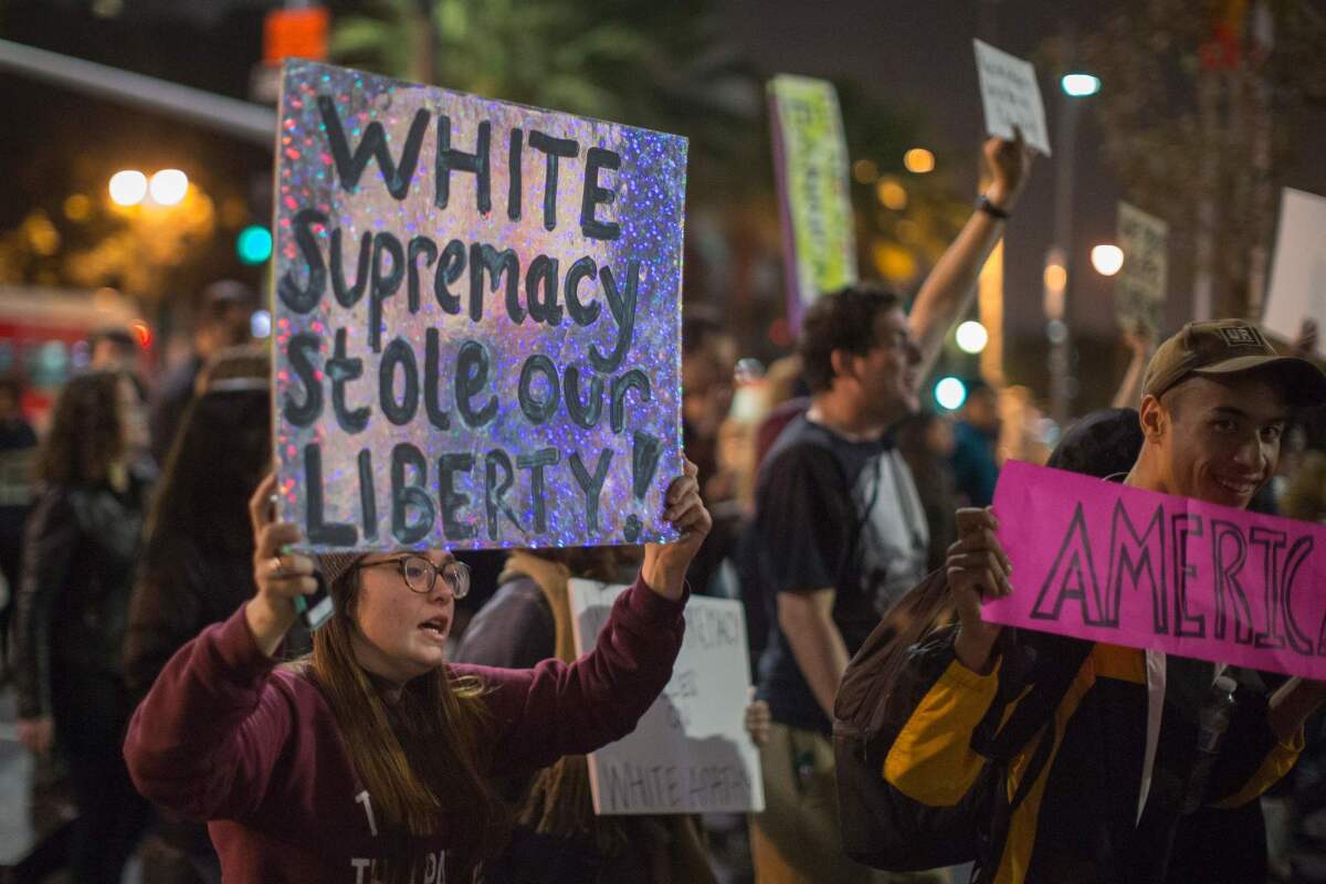 Protesters near L.A. City Hall on Nov. 16 call for President-elect Donald Trump to rescind his appointment of alt-right media mogul Steve Bannon as his chief adviser.