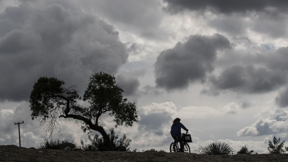 A storm front moves through the San Gabriel Valley late in March. Scattered storms are expected across Southern California through the weekend.